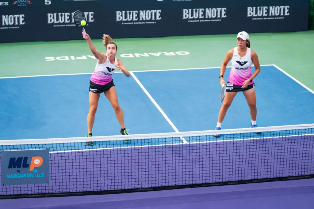 Photo of Las Vegas Night Owls' Judit Castillo Gargallo hitting pickleball while Chao Yi "Zoey" Wang watches